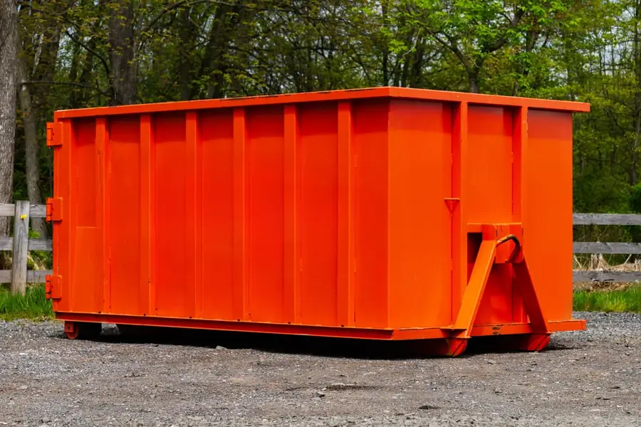 Small 10-yard roll-off dumpster on gravel